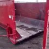 Side photo of red 15 yard dumpster rental with door