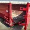 Side photo of red 20 yard dumpster rental with door for rent