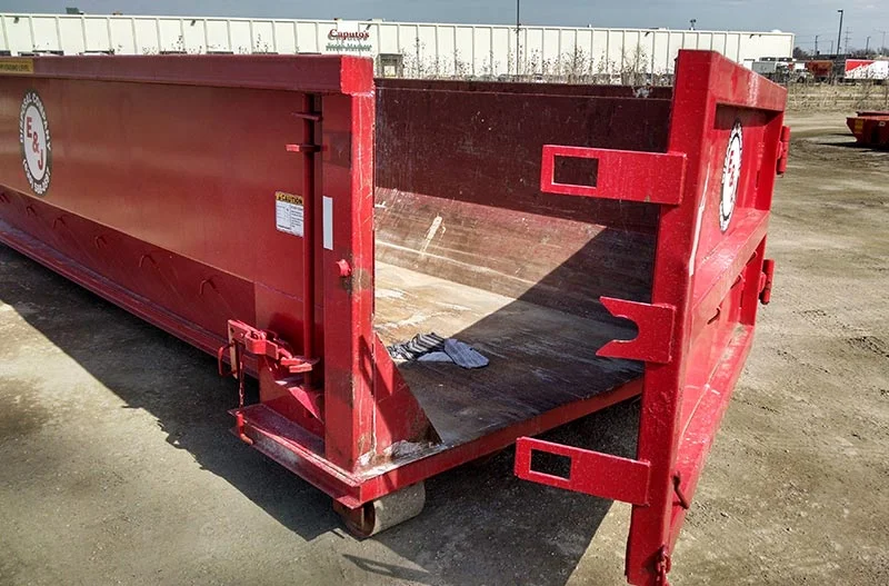 Side photo of red 20 yard dumpster rental with door for rent