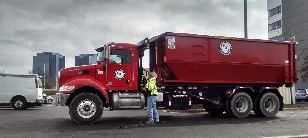 Arlington Heights dumpster rental company unloading roll-off container