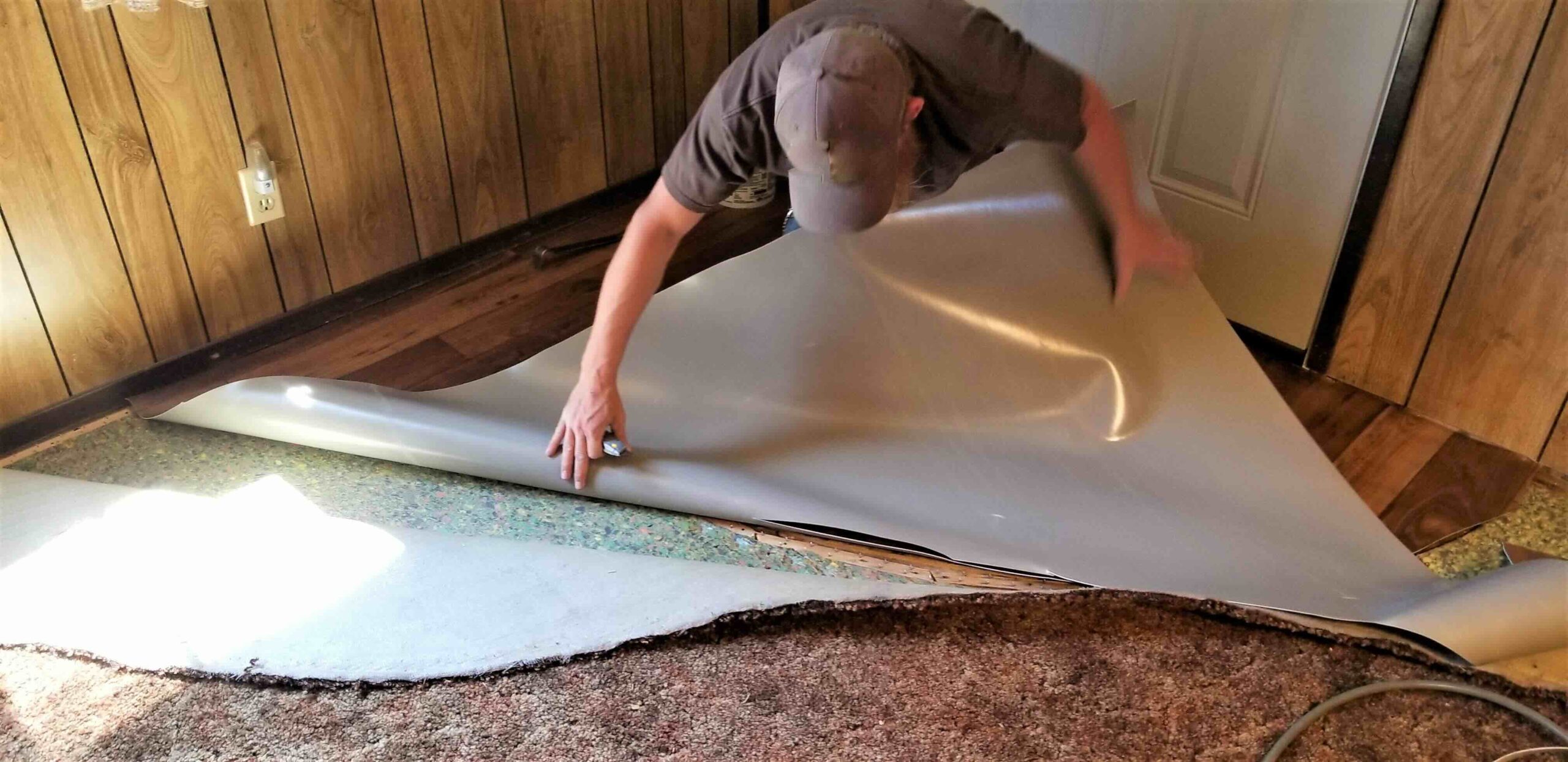 A photo of a carpet removal project being completed by a homeowner.
